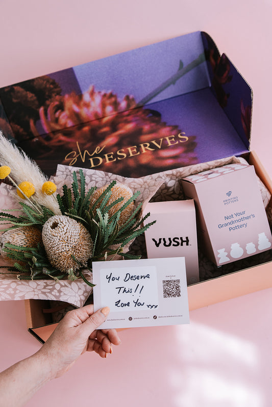 Petals & Pleasure Hamper open showing flowers, treats, and indulgent gifts for women